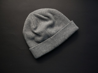 Gray worm winter woolen hat cap flat isolated on black background.