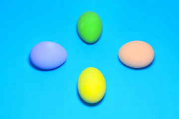 Easter eggs and text space on a blue background.