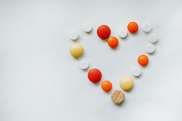 pills in the form of a heart on a white background