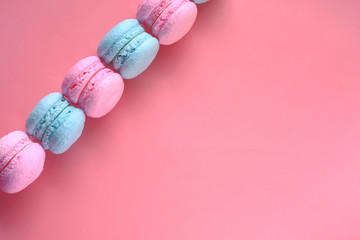 colorful macaroon in a row on pink background .