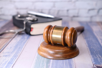 Close up of gavel, book and handcuff on table 