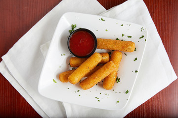 Classic cheesy mozzarella sticks with dipping sauce 