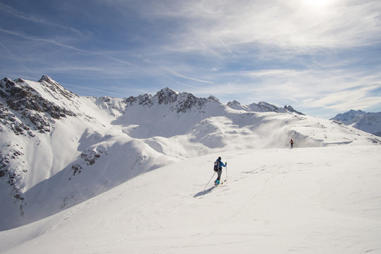 skitourers on plateau with stunning alpine view