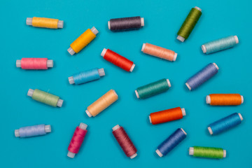 Multicolored cotton threads, spools, handmade sewing. Top view with copyspace, flat lay.