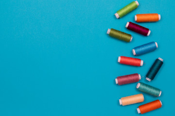 Multicolored cotton threads, spools, handmade sewing. Top view with copyspace, flat lay.