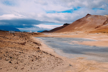 sulfuric springs in iceland yellow sand desert and walking tourists