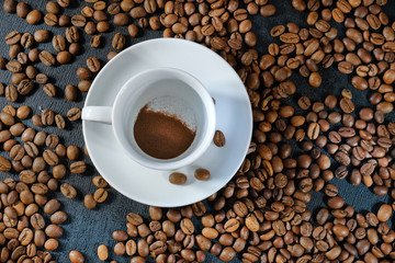 A cup of instant coffee and coffee beans close-up. View from above.