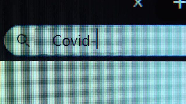 Browser bar with Covid-19 text typed on the computer monitor. Shot in 4k resolution