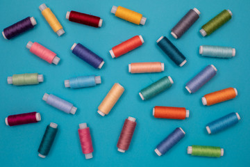 Multicolored cotton threads, spools, handmade sewing. Top view with copyspace, flat lay.