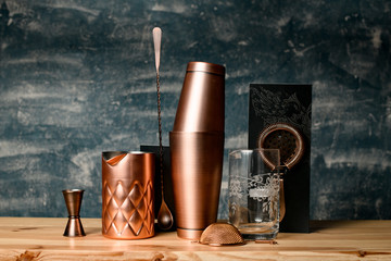Close-up. Several copper items of bar equipment stand at the bar.