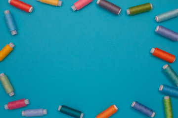 Multicolored cotton threads, spools, handmade sewing. Top view with copyspace, flat lay.