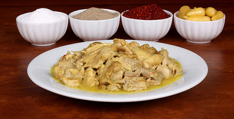 chicken with a very nice curry sauce on a white plate with fragrant Turkish spices