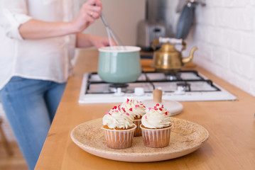 Fototapeta na wymiar girl making homemade cupcakes , cooking process, kitchen interior