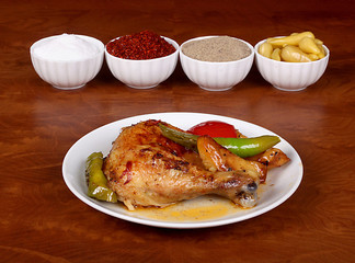 perfect turkish dish chicken leg spicy on white plate on wooden table