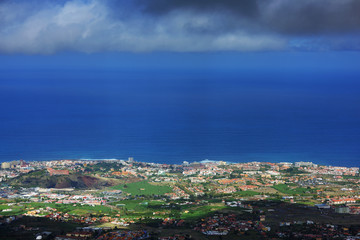 Fototapeta na wymiar Scenic View Of Clouds Over La Orotava Town At Tenerife By Blue Sea