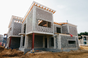 construction of a cottage with construction equipment in European design