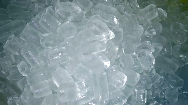 Slow motion , ice cubes dropping falling down into group of ice cubes background