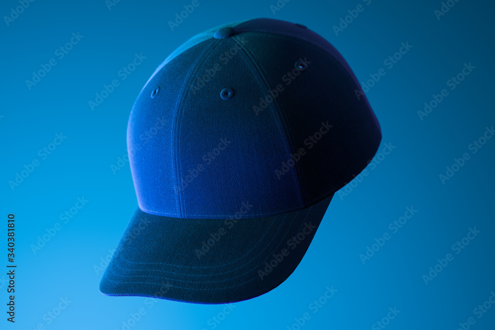 Poster dark realistic blank cap on blue background illuminated by neon light. 3d rendering.