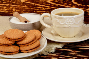 cookies next to a retro-style mug full of black coffee