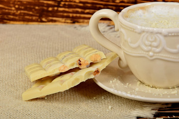 Obraz na płótnie Canvas coffee with white milk froth and pieces of white chocolate