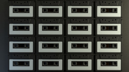 Grid pattern with retro audio cassettes on a black wooden background with depth of field. Vintage cassette close up. 3d render.