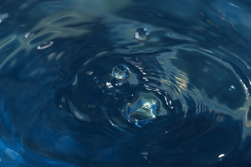 Blue water hole and ripple that effected from fallen droplet