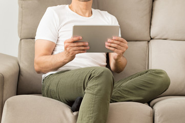 Man using his tablet at home
