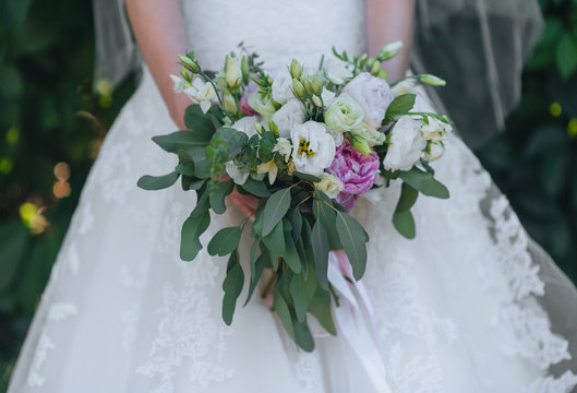 The bride holds a wedding bouquet close-up of roses and peonies. Photography, concept.