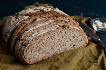 Homemade reshly baked country bread made from wheat and whole grain flour sliced with butter