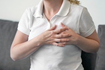 Woman having heart attack. Girl, hurts the heart. Woman having chest pain - heart attack.