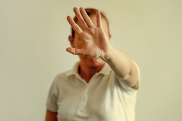 Woman Hide Her Face At Hand Woman Holding Her Hand Stretched Out Toward The Camera Covering Her Face Avoiding To Be Seen Or Stopping A Problems Wall Mural Polack