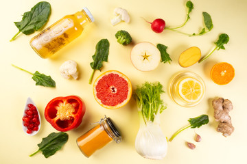Immune boosting health food and medical pills over yellow background