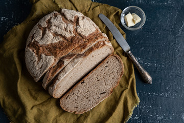 Homemade reshly baked country bread made from wheat and whole grain flour sliced with butter