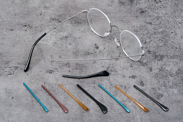 Closeup of glasses lying on table with many temples different color and form. Professional...