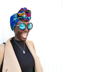 Trendy young African girl with head scarf and sun glasses