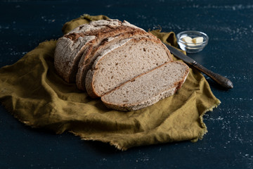Homemade reshly baked country bread made from wheat and whole grain flour sliced with butter