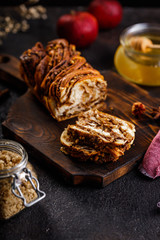 Swirl brioche or traditional Polish babka cake with walnut, apple and honey