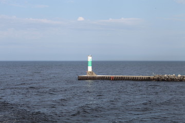 SUMMER DAY, WITH A LIGHTHOUSE ON THE LAKE, BLUE SKY, AND BLUE WATER