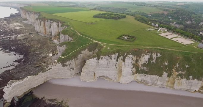 cliffs of Etretat in Normandy, France. Cliffs white work of nature, drone photos, camera movement to the side, view of golf courses, rocks, beaches and sea, shot in the early day, summer. 4k25ftp