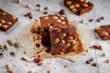 brownie cake wit hazelnut and chocolate on concrete table