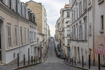 Horizontal view of a desertic street with a stoned road in Montmartre quarter of Paris, France