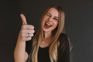 Happy young woman giving thumb up. selective focus