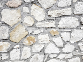 Old bright white pattern stone wall texture.