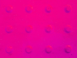 Pink abstract background with convex dots.