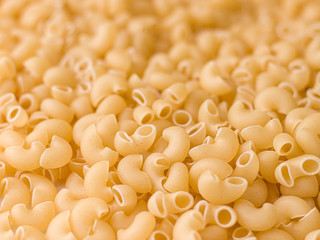 Uncooked macaroni elbow shape pasta with white background stock image. 