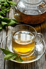 Close-up cup of mint tea with herbs