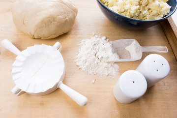 National Russian cuisine. Pierogi or pyrohy, vareniki, served with cottage cheese and potatoes on board.  Raw dumplings made of dough in handmade flour