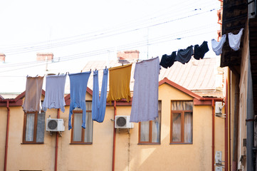 Washed clothes on laces for drying 