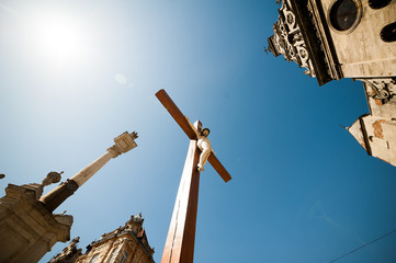 Big wooden christian cross near church
