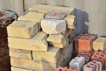 A pile of yellow and red bricks against the wall